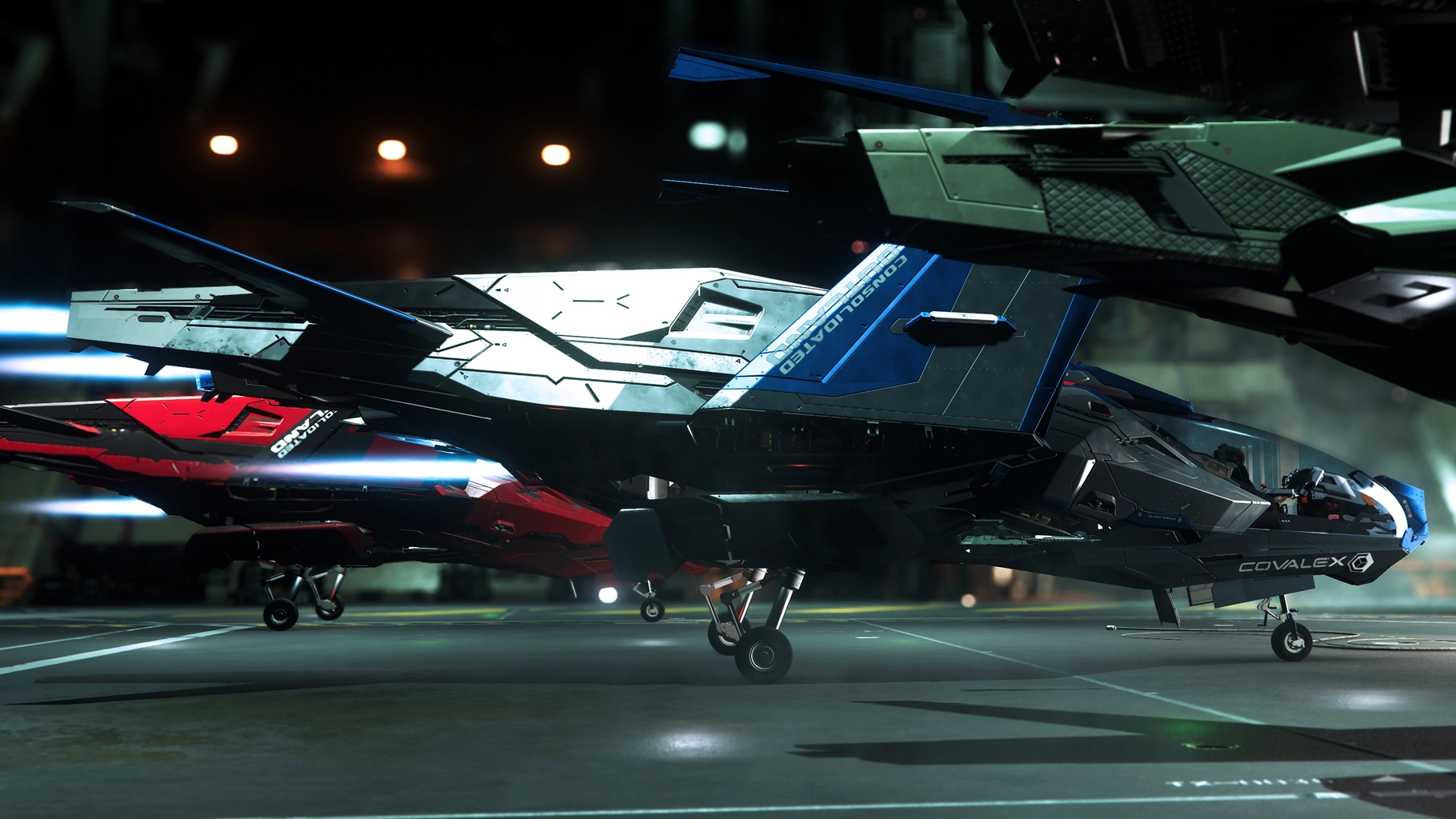 Mustang Gamma in a hangar beside a red racer