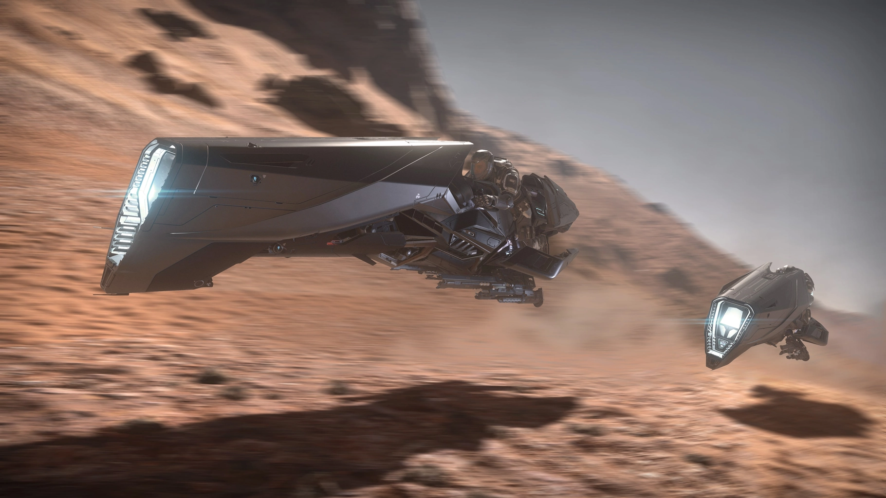 Aopoa Nox riders speeding across a sandy landscape