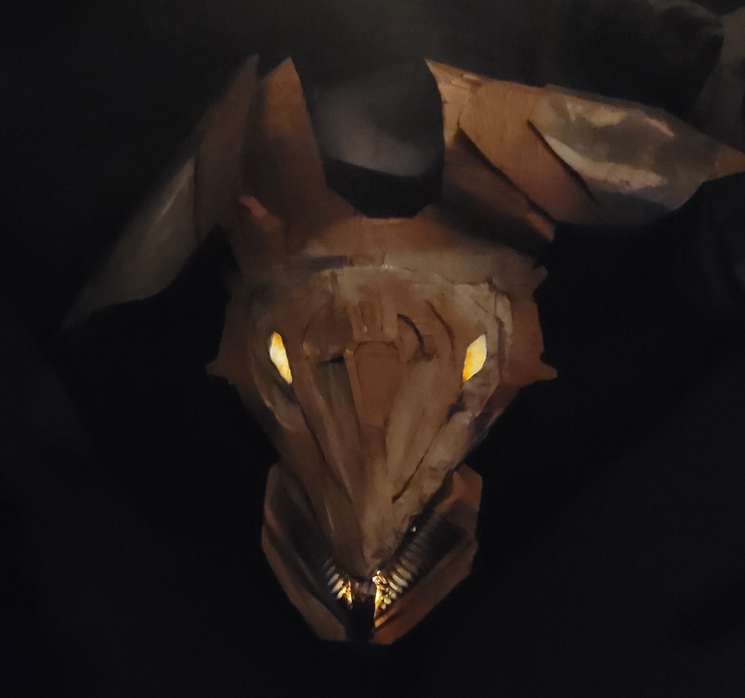 The armor was actually almost an afterthought, I scrapped it together from cardboard,  and lit the top half with a UV flashlight and fluorescent paint, and the bottom half with a stick-on battery powered LED and orange paint.