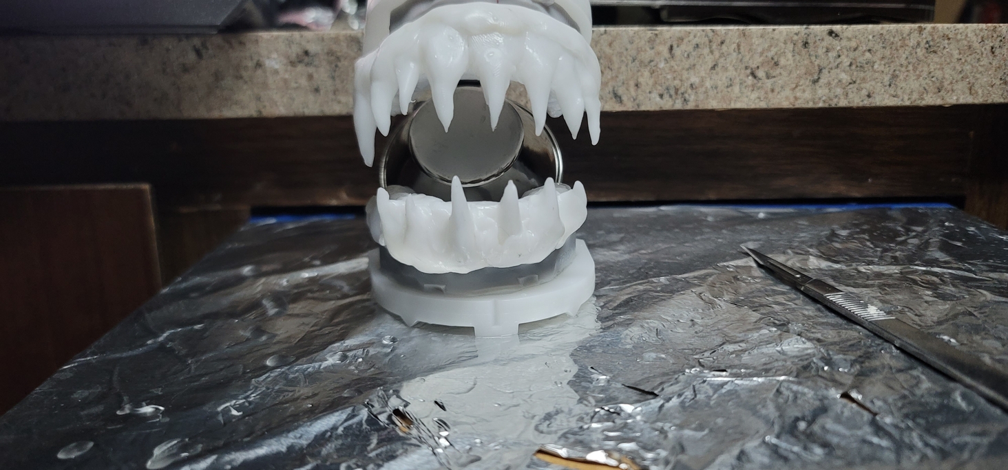thermoplastic beads can be had for quite cheap. they sell them to make temporary teeth, crowns, etc. and you can work then in hot water. I made a mouth guard set (upper and lower) and then made pointy teeth and stuck them on (these are pre-crown)